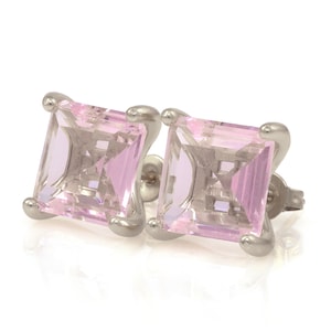 May include: A pair of silver earrings with pink square-shaped gemstones.