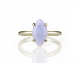 May include: A gold ring with a marquise-shaped lavender agate gemstone.