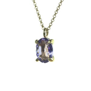 May include: A gold chain necklace with a purple oval gemstone pendant.