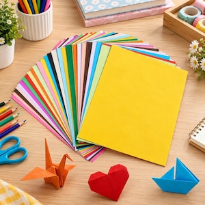May include: A large stack of rectangular construction paper sheets in a wide variety of solid colors, arranged in a fan shape. The collection includes shades of yellow, orange, red, pink, purple, blue, green, brown, black, and white paper.