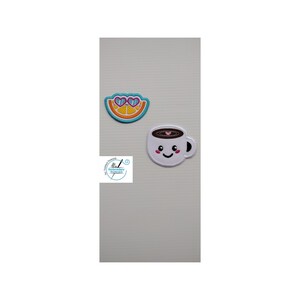 May include: Two embroidered iron-on patches. One is a yellow orange slice with blue sunglasses. The other is a white coffee cup with a brown coffee fill and a pink heart. Both have happy faces.