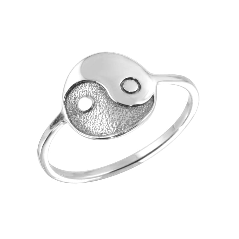 May include: A silver ring with a yin yang symbol design. The ring is simple and elegant.