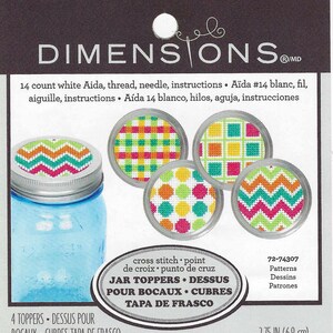 May include: Four colorful cross-stitch patterns for jar toppers. The patterns include a chevron, gingham, polka dot, and geometric design. The patterns are 2.75 inches in diameter.
