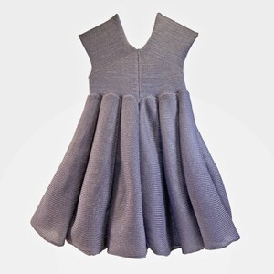 May include: A sleeveless, gray, knit dress with a gathered skirt.