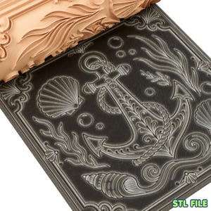 May include: A beige cylindrical rolling pin with a raised nautical pattern featuring an anchor, seashells, and seaweed, shown pressing into a dark gray surface to create a debossed design. The text STL FILE is visible in the bottom right corner.