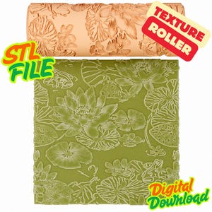 May include: A peach-colored cylindrical texture roller featuring an embossed lotus flower and frog pattern, positioned above a square green sheet displaying the same intricate floral and amphibian design. The image includes text reading STL FILE, TEXTURE ROLLER, and Digital Download.