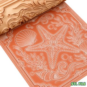 May include: A light orange textured rolling pin with a carved pattern of a starfish, seashells, and seaweed, shown alongside a flat, square clay tile embossed with the same detailed marine life design, featuring the text STL FILE in the corner.