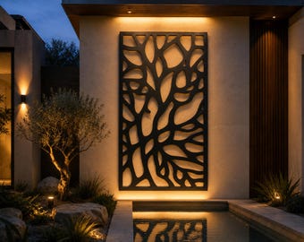 May include: A large, rectangular, black metal wall panel featuring an intricate, organic, branch-like cutout pattern. The panel is mounted vertically on a light-colored exterior wall, illuminated from behind by warm, ambient lighting.