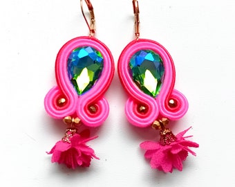 May include: A pair of pink and red earrings with iridescent green and blue teardrop-shaped crystals and pink flower accents.