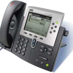 May include: A Cisco IP Phone 7960 series desk phone with a dark gray handset, a silver and black base, and a monochrome LCD screen displaying call information, including time, date, and active connection status with various function buttons.