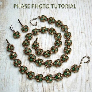 May include: A set of three beaded necklaces in green and gold. The necklaces are made of small, round beads and feature a delicate, floral design. The set includes a long necklace, a shorter necklace, and a bracelet.