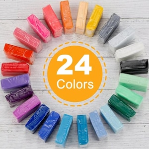 May include: A set of 24 rectangular blocks of modelling clay arranged in a circular pattern. The blocks feature a wide variety of colours including red, orange, yellow, green, blue, purple, pink, white, grey, and black. A central orange circle displays the text 24 Colors.