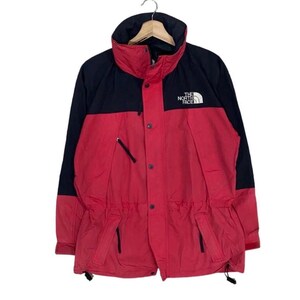May include: A red and black color-blocked jacket featuring a high collar, a front zipper closure with a snap-button placket, and the white The North Face logo embroidered on the upper left chest. The jacket includes long sleeves and a drawstring hem.