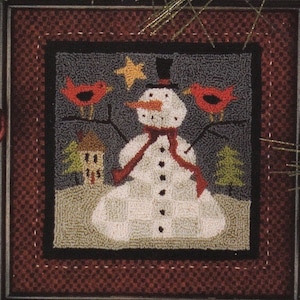 May include: A white snowman with a red scarf and black top hat stands in a snowy scene with two red cardinals perched on branches. A small house and a star are visible in the background.