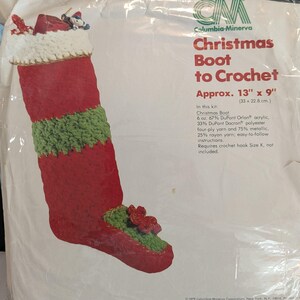 May include: A crochet kit for making a Christmas stocking boot. The kit includes 6 ounces of yarn in red and green, and instructions for crocheting the boot. The boot is approximately 13 inches by 9 inches.