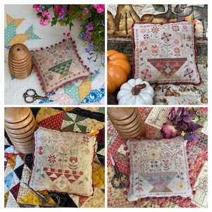 May include: Four handmade needlepoint pincushions with a floral design and a basket filled with flowers. Each pincushion is surrounded by a border of pom-poms and is displayed on a patchwork quilt.
