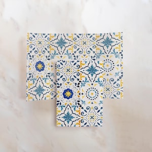 May include: Two sets of decorative tile stickers featuring a blue and yellow geometric pattern. The stickers are designed to look like traditional Spanish tiles.