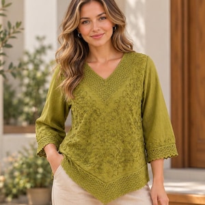 May include: An olive green V-neck blouse featuring intricate tonal embroidery on the front panel, three-quarter length sleeves, and a decorative crocheted lace trim along the neckline, sleeve cuffs, and the pointed hemline.