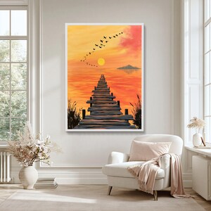 Könnte beinhalten: Ein vertikaler Wandkunstdruck, der einen Holzsteg zeigt, der in einen ruhigen orange-gelben Sonnenuntergang über dem Wasser führt. Ein Schwarm schwarzer Vögel fliegt in diagonaler Formation auf eine ferne Insel unter einer gelben Sonne zu.