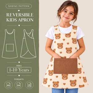 May include: A reversible kids apron featuring a cream-colored fabric with a repeating pattern of brown teddy bear faces and small hearts. The apron has a solid brown rectangular front pocket and a white t-shirt underneath.