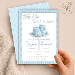 May include: A light blue baby shower invitation card featuring a pair of illustrated knitted booties. The text reads Tiny Shoes Little Steps Ahead, honoring Eugenia Fairmont on Saturday, June 26 at 5:00 PM at 210 Little Steps Lane.