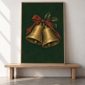May include: A framed wall art print featuring two metallic gold bells tied together with a vibrant red ribbon and accented with green holly leaves and small red berries, all set against a deep, solid dark green textured background.