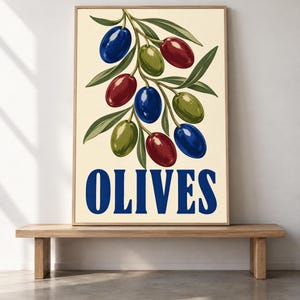 May include: A rectangular wall art print featuring a botanical illustration of an olive branch with blue, green, and red olives and pointed green leaves against a cream background. The word OLIVES is printed in large, bold, blue capital letters.