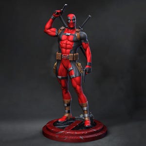 Può includere: Una statuetta di Deadpool in piedi che indossa una tuta tattica rossa e nera con cintura marrone, fondine e tasche. Il personaggio impugna una pistola nera, ha due spade sulla schiena e poggia su una base circolare di colore rosso.