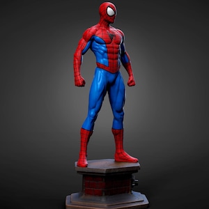 May include: A standing Spider-Man figurine featuring a red and blue suit with a black web pattern and a black spider emblem on the chest. The character is posed on a rectangular base designed to resemble a brick chimney structure with a dark finish.