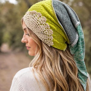 May include: A multi-textured head covering featuring a bright lime green fabric with a raised dot pattern, accented by a wide band of cream-coloured crocheted lace. The back section consists of a heathered grey and green fabric with visible seams.