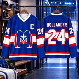 May include: A blue hockey jersey with white and red stripes on the sleeves and hem. The front features a white letter C and a logo with a fleur-de-lis. The back displays the name HOLLANDER and the number 24 in large white font with red trim.