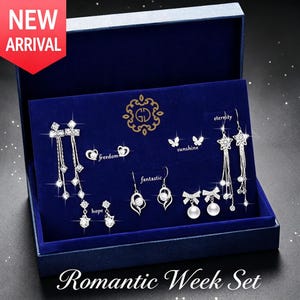 May include: A jewellery set in a blue box labelled Romantic Week Set, featuring silver-tone earrings with clear crystals and pearls. Designs include stars, butterflies, and bows, with text accents reading freedom, hope, sunshine, fantastic, and eternity.