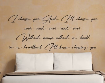 May include: A bedroom with a bed, two bedside tables, and a quote on the wall that reads "I choose you. And I'll choose you. over and over and over. Without pause, without a doubt. in a heartbeat. I'll keep choosing you."