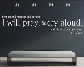 May include: A black and grey bench with a grey cushion in front of a dark grey wall with white text that reads "Evening and morning and at noon I will pray, & cry aloud, and He shall hear my voice. Psalm 55:17"