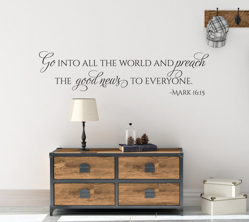 May include: A wall decal with a religious quote from the Bible: "Go into all the world and preach the good news to everyone. -Mark 16:15"