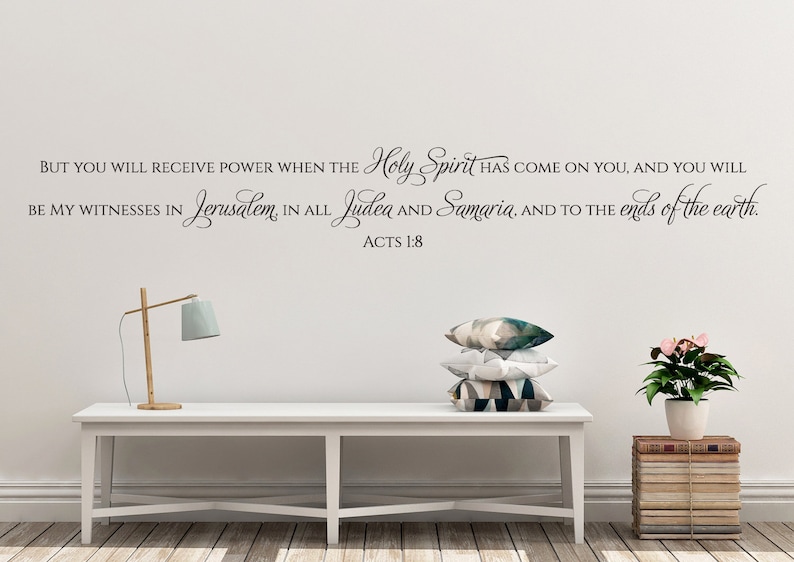 May include: A white wall with a black vinyl decal of a Bible verse from Acts 1:8. The verse reads "But you will receive power when the Holy Spirit has come on you, and you will be my witnesses in Jerusalem, in all Judea and Samaria, and to the ends of the earth. Acts 1:8".