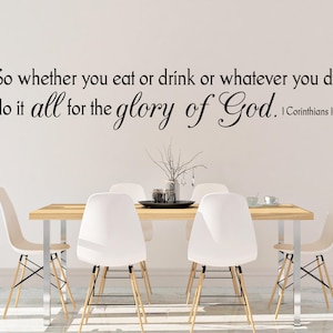 May include: A white wall with a black text quote that reads "So whether you eat or drink or whatever you do, do it all for the glory of God. 1 Corinthians 10:31". The quote is displayed above a dining table with four white chairs.