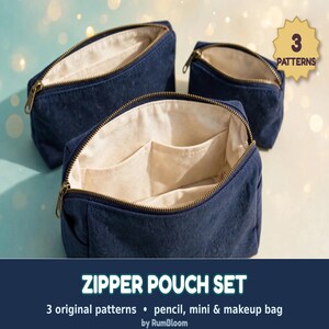 May include: A set of three navy blue zipper pouches with gold-toned metal zippers. The pouches feature a cream-colored interior lining with internal pockets. A gold star-shaped badge displays the text 3 PATTERNS.