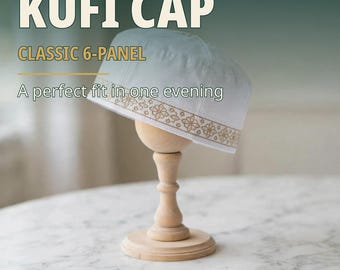 May include: A white 6-panel kufi cap featuring a gold-colored geometric floral border pattern along the bottom edge. The text KUFI CAP, CLASSIC 6-PANEL, and A perfect fit in one evening are visible on the image.