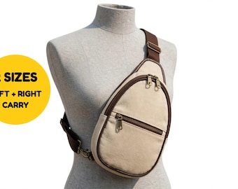 Könnte beinhalten: Eine beigefarbene, tropfenförmige Umhängetasche mit dunkelbraunen Kanten und Reißverschlüssen. Die Tasche hat ein Hauptfach und eine kleinere Vordertasche. Ein gelber Kreis zeigt den Text 2 SIZES LEFT + RIGHT CARRY.