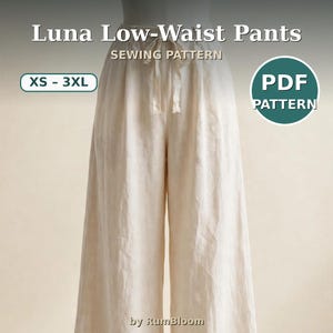 May include: Luna Low-Waist Pants sewing pattern in PDF format, sizes XS-3XL. The image displays off-white, wide-leg trousers with a drawstring waist tie, presented by RumBloom. The text reads Luna Low-Waist Pants, SEWING PATTERN, XS-3XL, PDF PATTERN, by RumBloom.