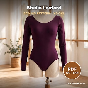 May include: A long-sleeve, deep purple leotard displayed on a mannequin. The text Studio Leotard SEWING PATTERN XS-3XL is visible at the top, and a brown circular badge with the text PDF PATTERN by RumBloom is in the bottom right corner.