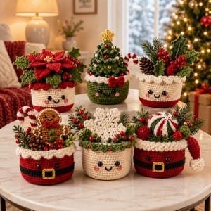 May include: Six crocheted holiday baskets with smiling faces, featuring festive decorations including a poinsettia, a Christmas tree, holly, a gingerbread man, a large white snowflake, and a peppermint candy, all arranged on a round table.