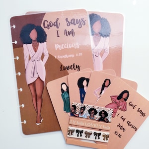 May include: A collection of stationery items featuring illustrations of women in various outfits. The items include planner inserts and cards with inspirational quotes like "God says I Am Precious" and "I Am Chosen". The color palette is primarily peach and brown.