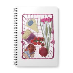 May include: A white spiral-bound notebook featuring a printed illustration of a maroon wire shopping basket filled with a wedge of cheese, a bouquet of pink tulips, a jar of jam, a cluster of red cherry tomatoes, and a single red pomegranate.