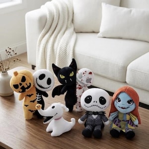 May include: A collection of six plush toys featuring characters from The Nightmare Before Christmas, including a pumpkin, a skeleton, a black bat, a white ghost dog, a pinstriped suit character, and a doll with long orange hair and a patchwork dress.
