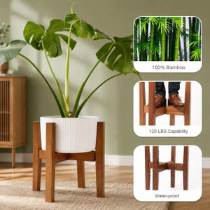 May include: A brown wooden plant stand with a white ribbed cylindrical pot holding a large green monstera plant. Insets show 100% bamboo material, a 120 lbs weight capacity with a person standing on the frame, and a water-proof finish.