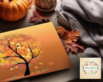 Könnte beinhalten: Eine herbstliche Szene mit einer Grußkarte, die einen Baum, Kürbisse und Herbstblätter zeigt. Die Karte zeigt eine schwarze Baumsilhouette mit einer farbenfrohen, blattgefüllten Krone. Es gibt einen kleinen, weißen Kürbis und einen größeren orangefarbenen Kürbis.