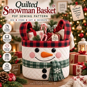 May include: A quilted white fabric basket featuring a snowman face with black button eyes, pink cheeks, and an orange carrot nose. It has a red and black buffalo plaid rim and handles, and a green plaid scarf with a white snowflake embroidery.