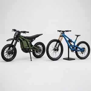 May include: An olive green electric dirt bike with black wheels and a kickstand positioned next to a bright blue mountain bike with gold-toned front suspension forks, black tires, and a black frame stand, both set against a plain white background.